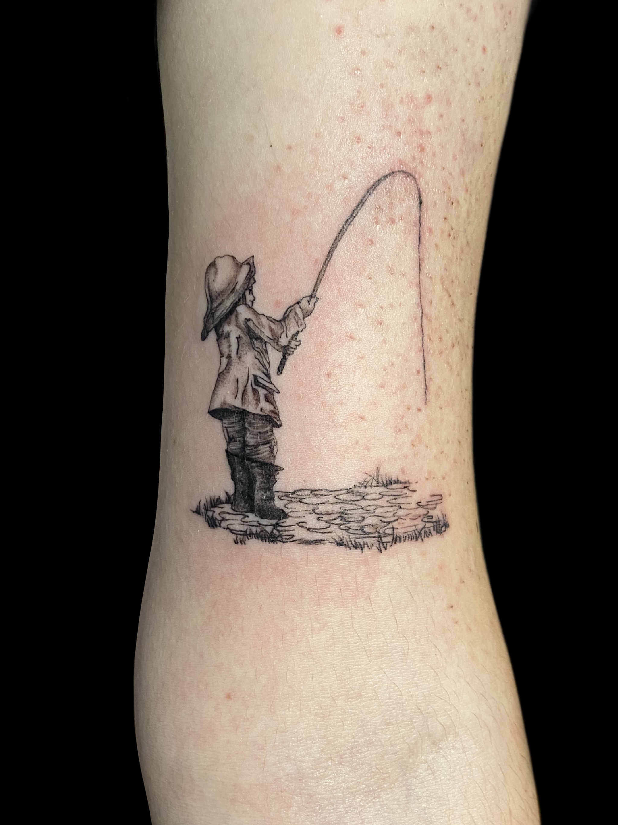 Fine line child fishing tattoo by Embodiment of Ink in South Surrey BC
